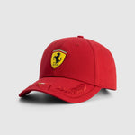 Red cap with Ferrari logo on a light gray background