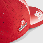 Red sports cap with UniCredit logo on a white background