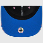 Blue cap with a brand logo on a light gray background