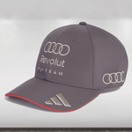 Gray cap with Audi and Revolut branding on a light gray background