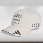 White cap with Audi and Revolut branding on a light gray background
