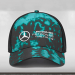 A multicolored tie-dye trucker cap with a Mercedes-AMG Petronas Formula One Team logo on the front, mesh back panels, and an adjustable snapback closure.
