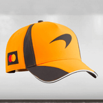 Orange and black cap with a logo on a light gray background