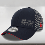 A navy-colored New Era 9FIFTY snapback cap with a Red Bull Racing logo on the front left, a red stripe detail on the rear arch, and a curved sandwich visor.