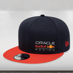 A black and orange New Era 9Fifty snapback cap with a flat visor, featuring embroidered eyelets and a printed Oracle Red Bull Racing color logo on the left front crown, and an adjustable snap closure.