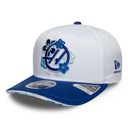 White and blue cap with floral design and New Era logo on a white background