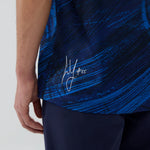 Blue athletic shirt with a signature design on a white background