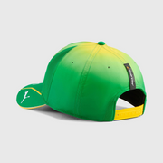 Green and yellow cap with a logo on a light gray background