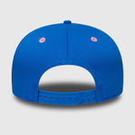 Blue cap with pink dots on a light gray background