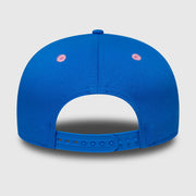 Blue cap with pink dots on a light gray background