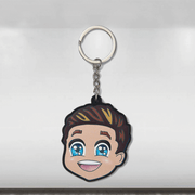 A colorful caricature keyring featuring a smiling cartoon character with blue eyes and a Mercedes-Benz logo on the keyring.