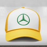 A Mercedes AMG Petronas F1 cap with a yellow and white color scheme, featuring the green Mercedes star logo, celebrating the Lewis Hamilton Special Edition Silverstone.