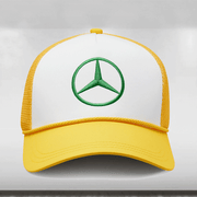 A Mercedes AMG Petronas F1 cap with a yellow and white color scheme, featuring the green Mercedes star logo, celebrating the Lewis Hamilton Special Edition Silverstone.