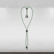 Green and black braided lanyard with metal clips on a gray background