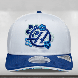 White cap with blue floral design and logo on a light gray background