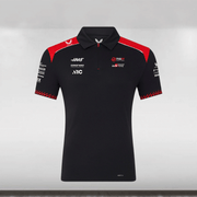Black polo shirt with red and white accents on a gray background