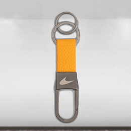 Keychain with orange strap and Nike logo on a light gray background