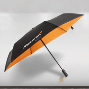 Black and orange umbrella with McLaren logo on a gray background