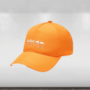 An orange baseball cap with the Red Bull Racing logo on the crown and a peak.