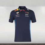 An official 2024 Red Bull Racing Team navy polo shirt with a subtle jacquard matte-knitted fabric, featuring a contrast pointed collar, concealed button placket, and screen-printed graphic at the back. The shirt includes branding at the chest, arms, and back, and is displayed against a plain background.