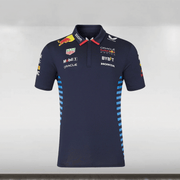 An official 2024 Red Bull Racing Team navy polo shirt with a subtle jacquard matte-knitted fabric, featuring a contrast pointed collar, concealed button placket, and screen-printed graphic at the back. The shirt includes branding at the chest, arms, and back, and is displayed against a plain background.