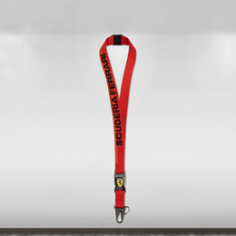 Red lanyard with 'Scuderia Ferrari' branding on a white background