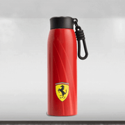 Red water bottle with Ferrari logo on a light gray background